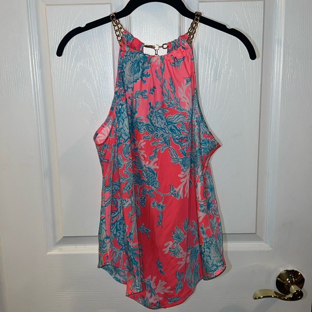 Lilly Pulitzer top with gold chain detail around neck line.